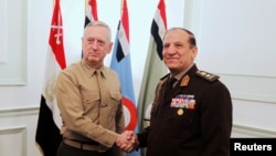 FILE - Egypt's Chief of Staff of the Armed Forces Sami Annan, right, shakes hands with the U.S. Commander of the Central Command James Mattis during a meeting in Cairo, Egypt, March 29, 2011.