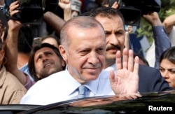 FILE - Turkish President Recep Tayyip Erdogan waves to supporters as he leaves his residence in Istanbul, June 24, 2018.