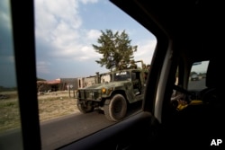 A military convoy patrols a road near Palmarito Tochapan in Puebla State, May 10, 2017.