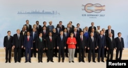 The leaders attending the G-20 summit in Hamburg, Germany, pose for a photo, July 7, 2017.