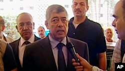 In this image from Egyptian State Television, Egyptian Interior Minister Mohamed Ibrahim responds to a reporter after an explosion near his convoy in Cairo, Sept. 5, 2013.