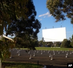 This drive-in theater is in Australia, but the photo gives you a good idea of how the speakers are lined up and waiting for cars and their occupants to arrive for the show.
