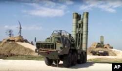 This photo made from the footage taken from the Russian Defense Ministry official web site on Nov. 27, 2015, shows Russian S-400 air defense missiles being deployed at the Hemeimeem air base in Syria.