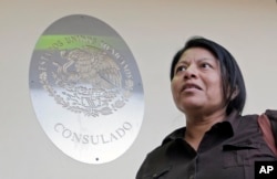 Undocumented immigrant Divina Ciriaco, of Mexico, talks to a reporter, at the Mexican Consulate, March 3, 2017, in Miami.