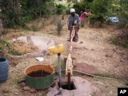Ethiopian “farmer-priest” Kas Malede Abreha works the water pump he built … The simple contraption has changed his life …