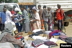 FILE - Families queue at a United Nations Human Rights Council (UNHRC) center for Burundi refugees in Uvira to receive food ration and clothing in South Kivu in the Democratic Republic of Congo (DRC) May 20, 2015.