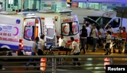 Paramedics push a stretcher at Turkey's largest airport, Istanbul Ataturk, following a blast in Turkey, June 28, 2016.