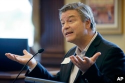 FILE - Jerry Schnoor, of the University of Iowa, speaks during a two-day meeting of the Task Force on Climate Preparedness and Resilience, May 13, 2014, in Des Moines, Iowa. Governors, mayors and other local government officials discussed the impact of changing weather patterns and the effect on food production, health and ability to prepare for flooding and drought. President Donald Trump has since disbanded the group, which his predecessor created.