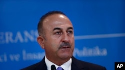 FILE - Turkey's Foreign Minister Mevlut Cavusoglu, listens to a reporter's question during a joint news conference with Russia's Foreign Minister Sergey Lavrov (not pictured), in Ankara, Turkey, Aug. 14, 2018.