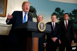 FILE - President Donald Trump speaks before signing a presidential memorandum on the imposition of tariffs and investment restrictions on China, in the Diplomatic Reception Room of the White House, March 22, 2018, in Washington.