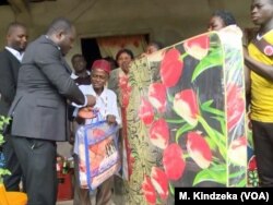 Man receiving assistance from a government official in Mamfe, Cameroon, Dec. 20, 2018.
