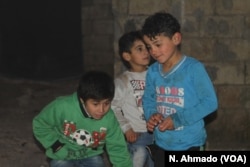 Hoger, in a green shirt, plays with other children in Atmeh refugee camp in northern Syria. Hoger was surrendered to an orphanage in Atmeh several months ago.