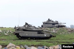 FILE - Israeli soldiers take part in an exercise in the Israeli-occupied Golan Heights, near the cease-fire line between Israel and Syria, March 20, 2017.
