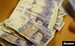 FILE - British Pound Sterling banknotes are seen at the Money Service Austria company's headquarters in Vienna, Austria.