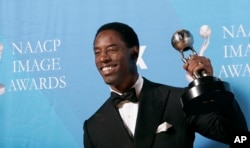 FILE - Isaiah Washington holds the award for outstanding actor in a drama series for his work on "Grey's Anatomy" at the 38th NAACP Image Awards in Los Angeles, March 2, 2007.