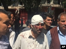 FILE - An injured man is seen after an explosion in Kabul, Afghanistan, May 31, 2017.