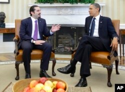 FILE - In this Jan. 12, 2011 photo, President Barack Obama meets with Lebanese Prime Minister Saad Hariri, in the Oval Office of the White House in Washington. Hariri who resigned from Saudi Arabia nearly two weeks ago has been caught in the crossfire between the region’s two feuding powers - Sunni Saudi Arabia and Shiite Iran.