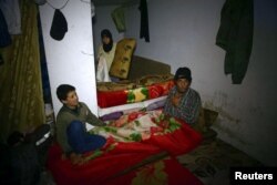 A man gestures as he sits in a shelter in the besieged town of Douma, eastern Ghouta, in Damascus, Syria, March 11, 2018.