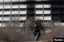 An Afghan policeman walks in front of the Intercontinental Hotel a day after an attack in Kabul, Afghanistan, Jan. 22, 2018.