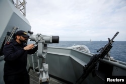 FILE - A crew member is seen on the deck of Spain's navy frigate Mendez Nunez as it participates in NATO exercises in the Mediterranean sea, March 13, 2017.