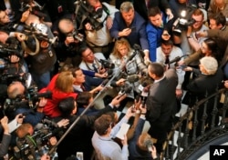 Virginia Lt. Gov. Justin Fairfax, center right, speaks to the media in the rotunda in front of the statue of George Washington at the Capitol in Richmond, Virginia, Feb. 4, 2019.