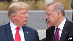 FILE - President Donald Trump, left, talks to Turkish President Recep Tayyip Erdogan, right, as they tour the new NATO headquarters in Brussels, July 11, 2018.