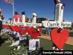 FILE - Crosses, erected in a graceful, curvy line behind the “Welcome to Las Vegas” sign, serve as markers of the lives of those who died when a gunman opened fire Oct. 1, 2017, at the crowd attending a country music concert in Las Vegas.