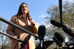 White House press secretary Sarah Sanders speaks to reporters outside the West Wing of the White House, March 25, 2019.