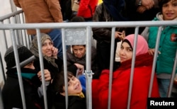 Migrants queue inside a tent at the compound outside the Berlin Office of Health and Social Affairs (LAGESO) waiting to register in Berlin, Germany, Dec. 1, 2015.