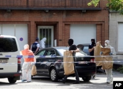 FILE - Police and forensic officers remove items during a house search in the Molenbeek district of Brussels, June 21, 2017. Belgian authorities said they foiled a terror attack when soldiers shot a suspect in the heart of Brussels after a small explosion at a busy train station June 20 that continued a week of attacks in the capitals of Europe.