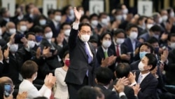 Then-Foreign Minister Fumio Kishida gestures as he is elected as new head of the ruling party