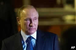 FILE - Russian President Vladimir Putin, pictured in Hamburg, Germany, July 7, 2017, most likely expected the Trump administration would return Russian compounds seized by the previous U.S. administration, veteran diplomat John Herbst says.