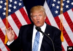 FILE - Then-presidential candidate Donald Trump speaks during a campaign rally at the Phoenix Convention Center in Phoenix, Aug. 31, 2016.