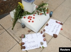 People pay their respects to Winnie Madikizela-Mandela with messages of condolence and flowers in Durban, South Africa, April 3, 2018.