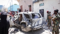 Security forces observe the scene of a suicide bombing that injured Somalia's government spokesperson Mohamed Ibrahim Moalimuu in Mogadishu, Somalia, Jan. 16, 2022.