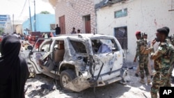 Security forces observe the scene of a suicide bombing that injured Somalia's government spokesperson Mohamed Ibrahim Moalimuu in Mogadishu, Somalia, Jan. 16, 2022.