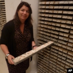 Core Repository Director Maureen Raymo pulls out a sea sediment sample, one of thousands at the archive.