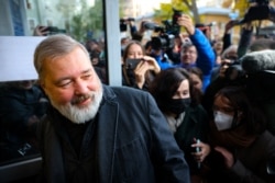 FILE - Russia's top independent newspaper Novaya Gazeta chief editor Dmitry Muratov meets with reporters outside the newspaper's office, in Moscow, Oct. 8, 2021.