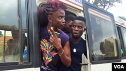 After stopping on the side of the road, LGBT Ugandans emerged from the buses demanding answers from the police. (L. Paulat/VOA)