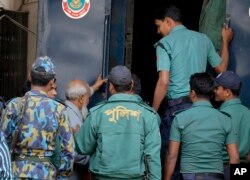 Bangladeshi policemen escort Obaidul Haque Taher, third from left, after he was sentenced to death for his involvement in killing, kidnapping and looting during the country's independence war against Pakistan in 1971, by a Bangladeshi tribunal in Dhaka, Feb. 2, 2016.