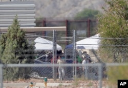 Detainees are seen at a facility where tent shelters are being used to house separated family members at the Port of Entry, June 21, 2018, in Fabens, Texas.