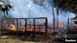 A house is seen on fire in Gawduthar village, Maungdaw township, in the north of Rakhine state, Myanmar, Sept. 7, 2017.