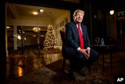 FILE - Republican presidential candidate Donald Trump speaks during an interview at the Trump National Golf Club in Sterling, Virginia, Dec. 2, 2015.