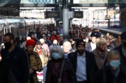 People walk along a platform after departing from a train at King's Cross Station, amid the COVID-19 outbreak in London, Britain, October 21, 2021.