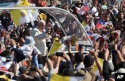 FILE - Pope Francis arrives on the pope-mobile to the Maquehue Air Base, to celebrate a Mass in Temuco, Chile, Jan. 17, 2018.