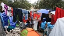 A child walks among laundry hung to dry after a rainstorm in the tent camp in Reynosa. (Dylan Baddour/VOA)