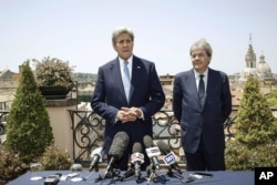 U.S. Secretary of State John Kerry, left, is flanked by Italian Foreign Minister Paolo Gentiloni, during a press conference that followed their meeting in Rome, Sunday, June 26, 2016.