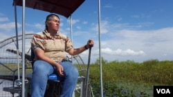 Betty Osceola, a member of the Miccosukee tribe, runs an airboat tour company in the Everglades, where persistent economic development threatens indigenous lands and sacred burial grounds. (W. Gallo/VOA)