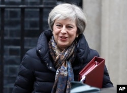 Britain's Prime Minister Theresa May leaves 10 Downing Street to attend parliament in London, Jan. 25, 2017.