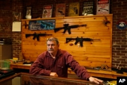 Bob Hagopian works in his gun shop in Maine on Oct. 20, 2016.